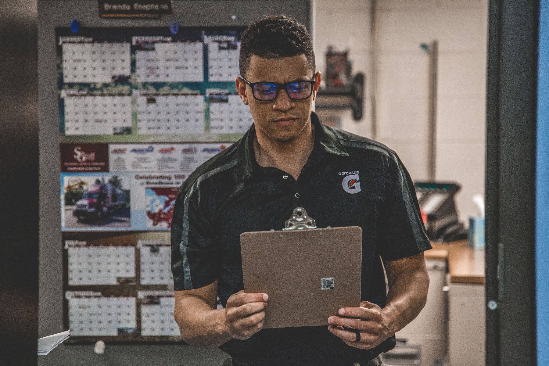A man checking his writepad for packaging quotation A man checking his writepad for packaging quotation
